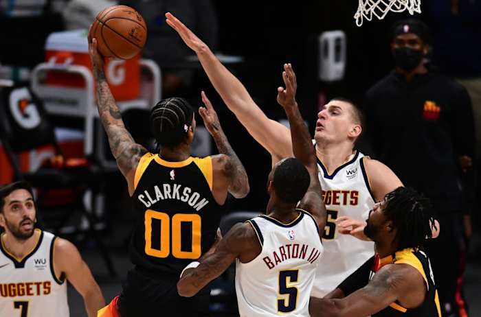 Jordan Clarkson (00) shoots over Nikola Jokic (15) 